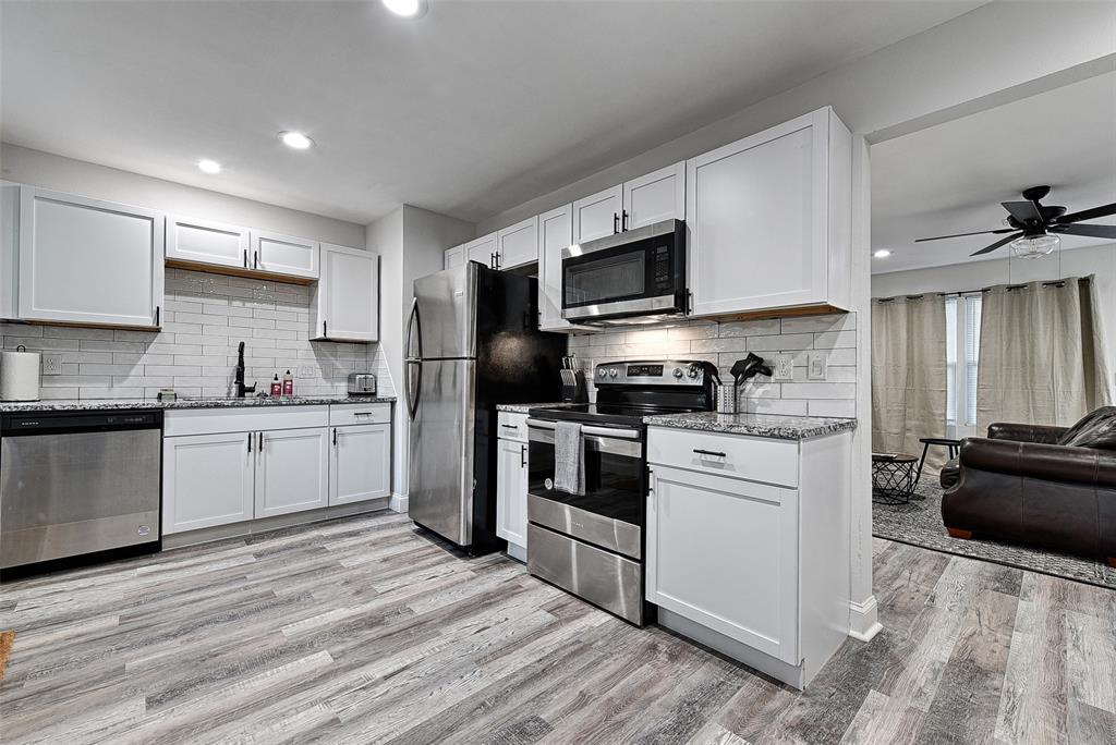 1201 Ridgewood Road Denison, TX 75020 - Photo 5 of 29 Kitchen with stainless steel appliances, light hardwood / wood-style floors, and white cabinetry