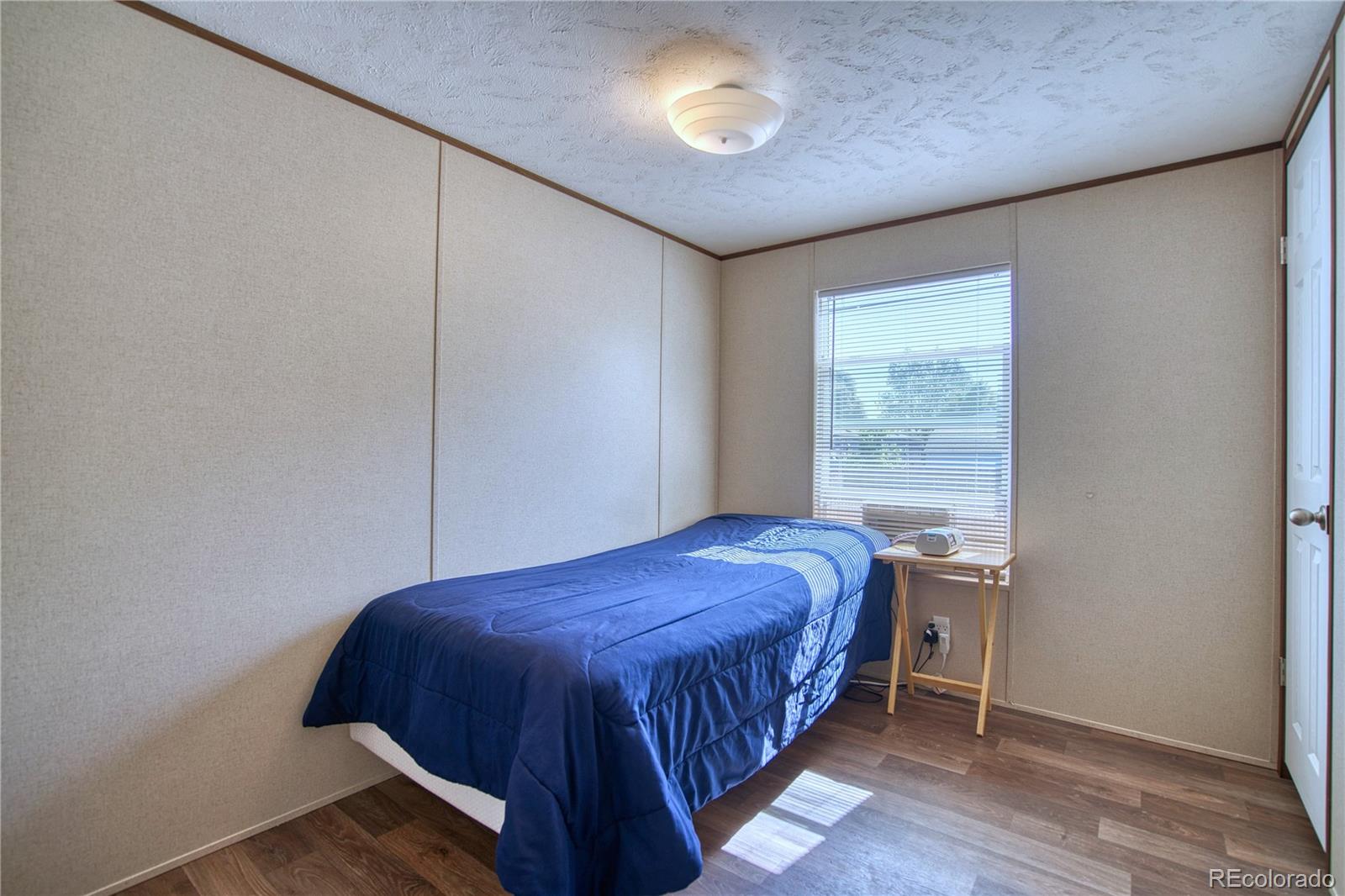 218 Grape Street Hudson, CO 80642 - Photo 11 of 17 a bedroom with a bed and a window