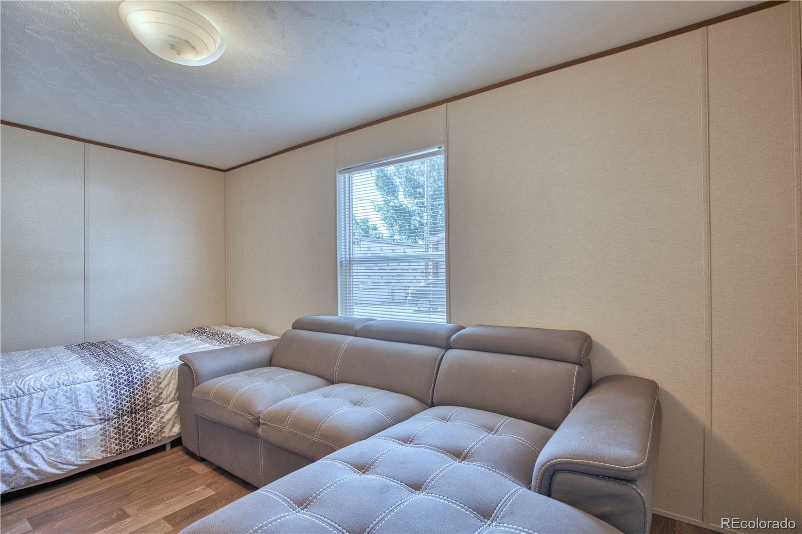 218 Grape Street Hudson, CO 80642 - Photo 12 of 17 a living room with furniture and a window