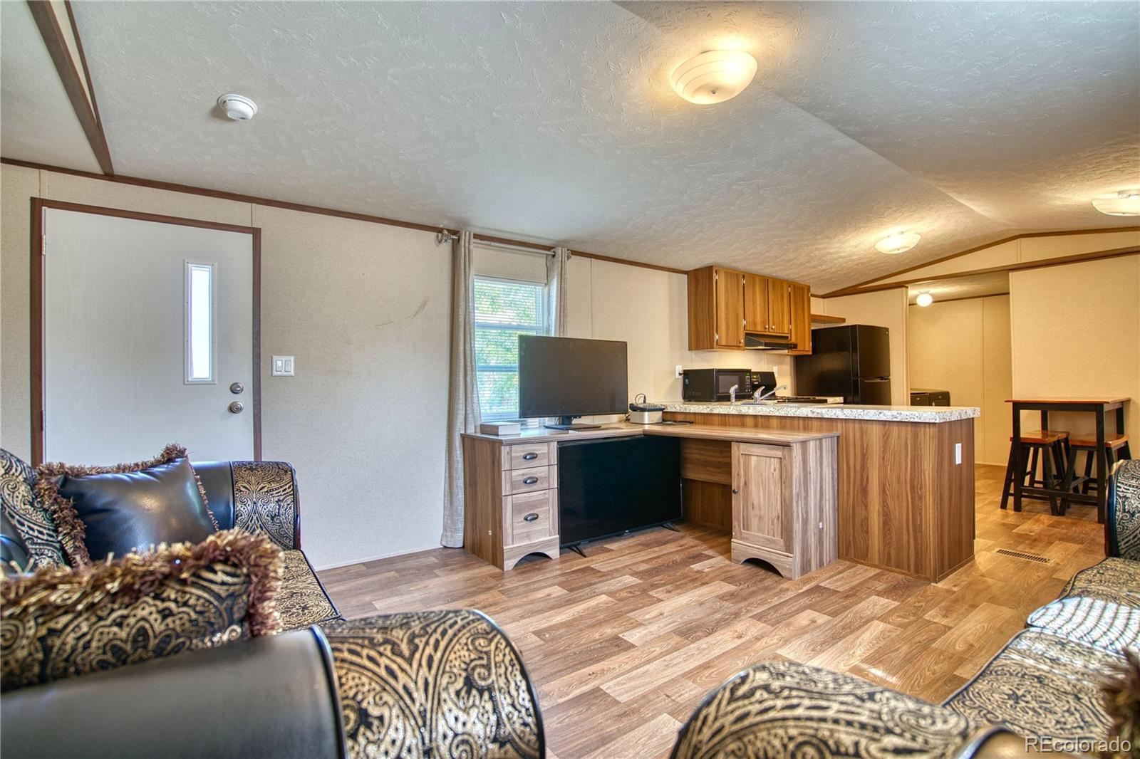 218 Grape Street Hudson, CO 80642 - Photo 4 of 17 a bedroom with a bed and a television