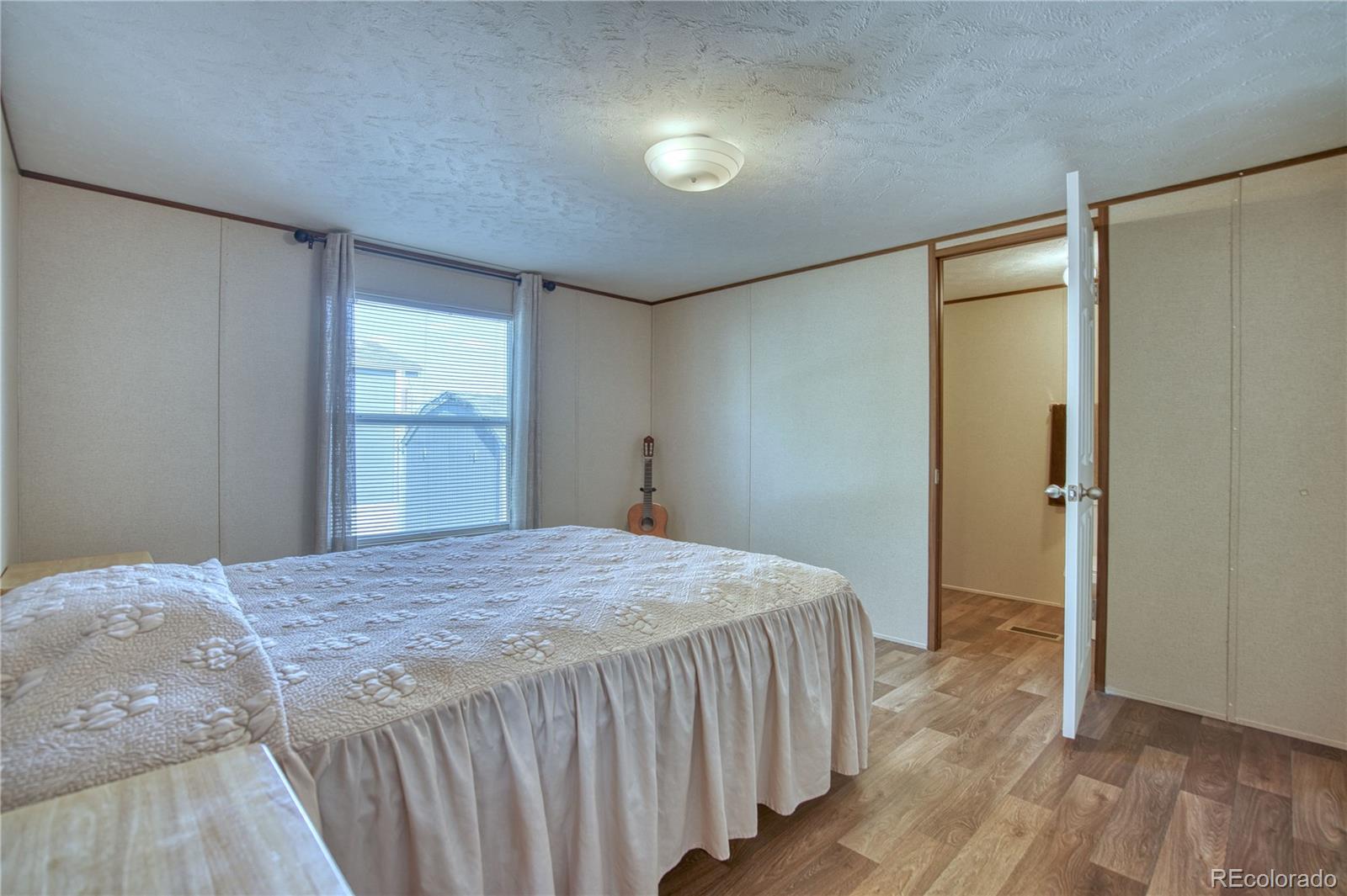 218 Grape Street Hudson, CO 80642 - Photo 6 of 17 a bedroom with a bed and a dresser
