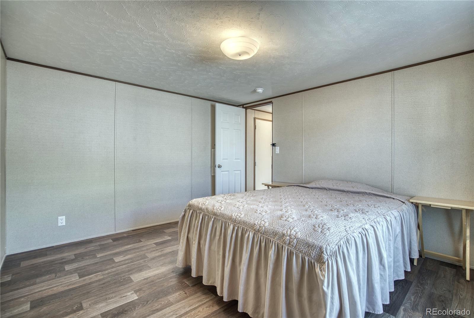 218 Grape Street Hudson, CO 80642 - Photo 7 of 17 a bedroom with a bed and a window