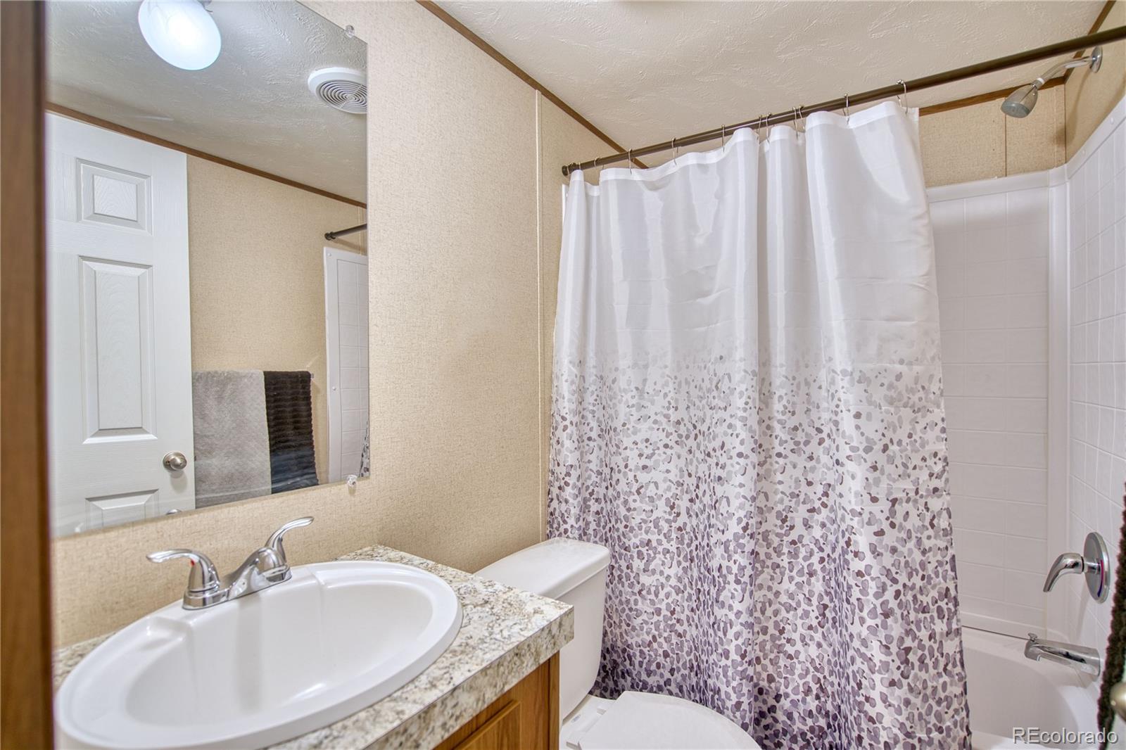 218 Grape Street Hudson, CO 80642 - Photo 9 of 17 a bathroom with a sink toilet and shower