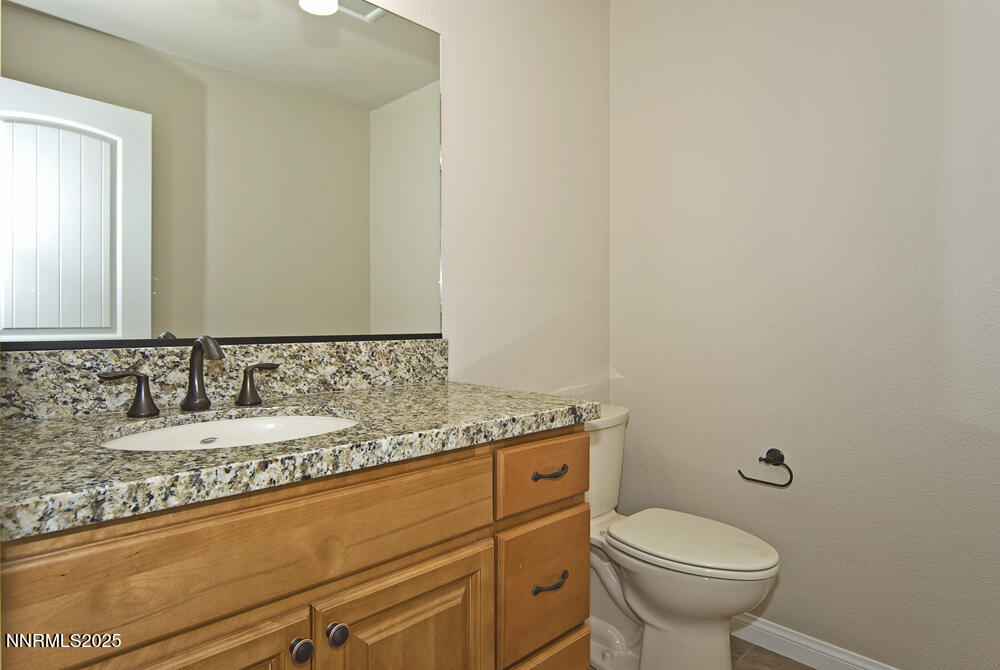 646 Anderson Street Carson City, NV 89701 - Photo 11 of 25 a bathroom with a granite countertop sink and a mirror