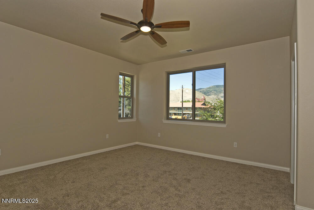646 Anderson Street Carson City, NV 89701 - Photo 13 of 25 an empty room with a window and a fan