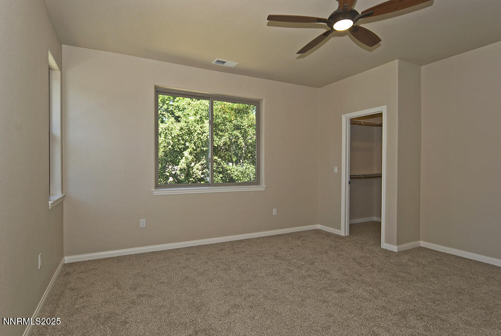 646 Anderson Street Carson City, NV 89701 - Photo 14 of 25 an empty room with a window and a fan