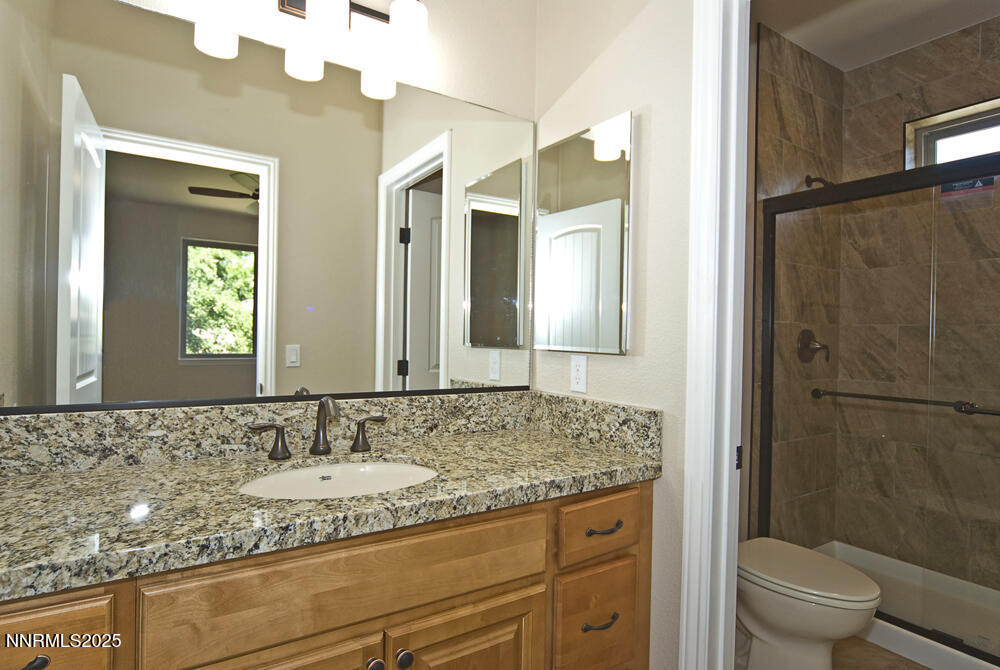 646 Anderson Street Carson City, NV 89701 - Photo 15 of 25 a bathroom with a granite countertop sink and a mirror