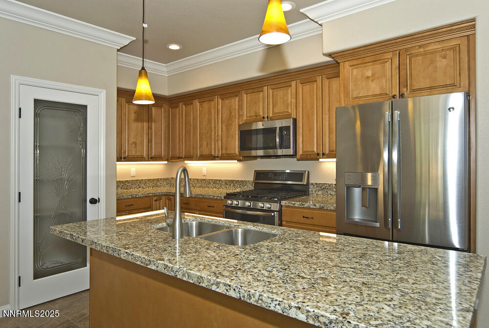 646 Anderson Street Carson City, NV 89701 - Photo 3 of 25 a kitchen with stainless steel appliances granite countertop a refrigerator a stove and a sink with granite countertops