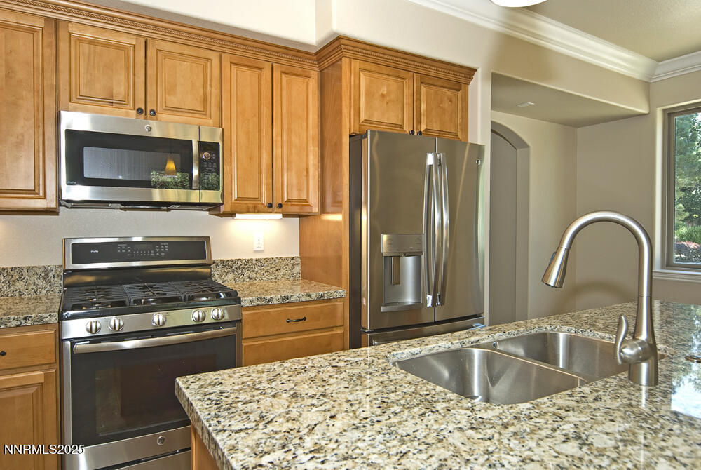 646 Anderson Street Carson City, NV 89701 - Photo 4 of 25 a kitchen with granite countertop a stove and a microwave