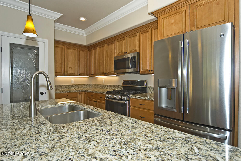 646 Anderson Street Carson City, NV 89701 - Photo 6 of 25 a kitchen with stainless steel appliances granite countertop a refrigerator a stove top oven and a sink