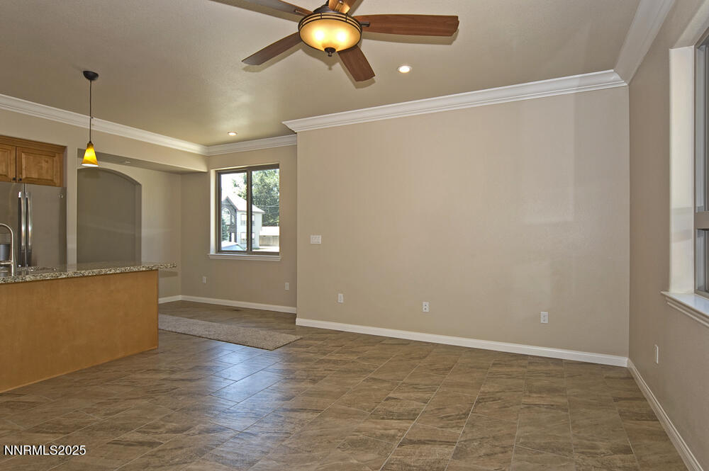 646 Anderson Street Carson City, NV 89701 - Photo 9 of 25 a view of an empty room with window and wooden floor