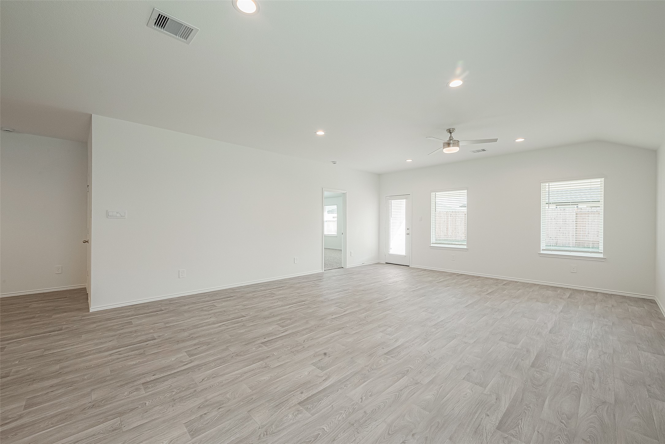 2731 Willow Gulch Way Rosenberg, TX 77469 - Photo 11 of 50 a view of an empty room with a window and wooden floor