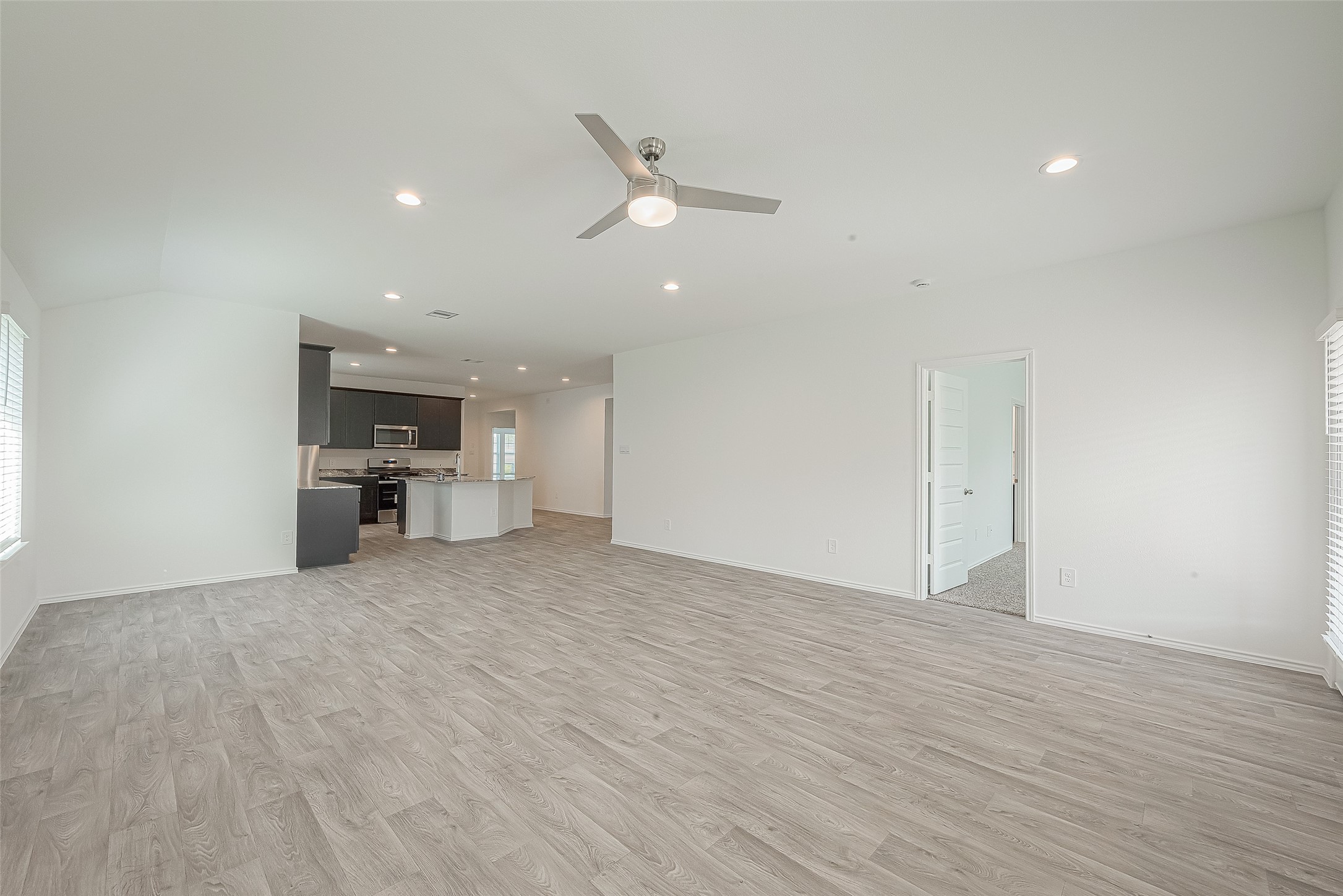 2731 Willow Gulch Way Rosenberg, TX 77469 - Photo 12 of 50 a view of a kitchen with a sink and dishwasher a refrigerator with wooden floor