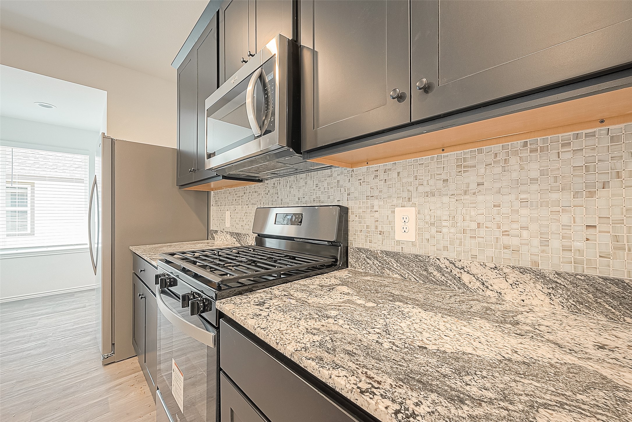 2731 Willow Gulch Way Rosenberg, TX 77469 - Photo 17 of 50 a kitchen with granite countertop a stove and a sink
