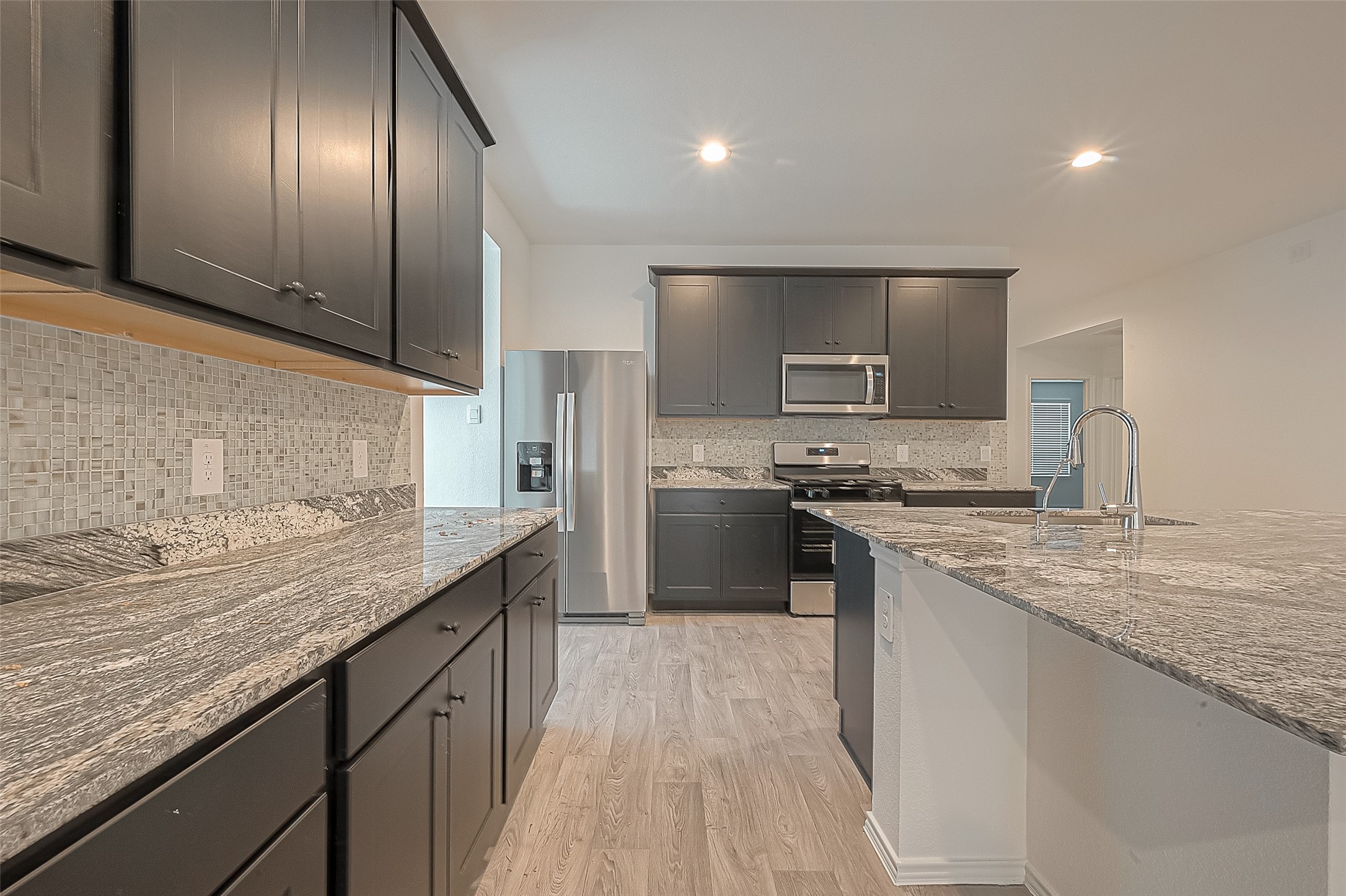 2731 Willow Gulch Way Rosenberg, TX 77469 - Photo 18 of 50 a kitchen with stainless steel appliances granite countertop a sink stove and refrigerator