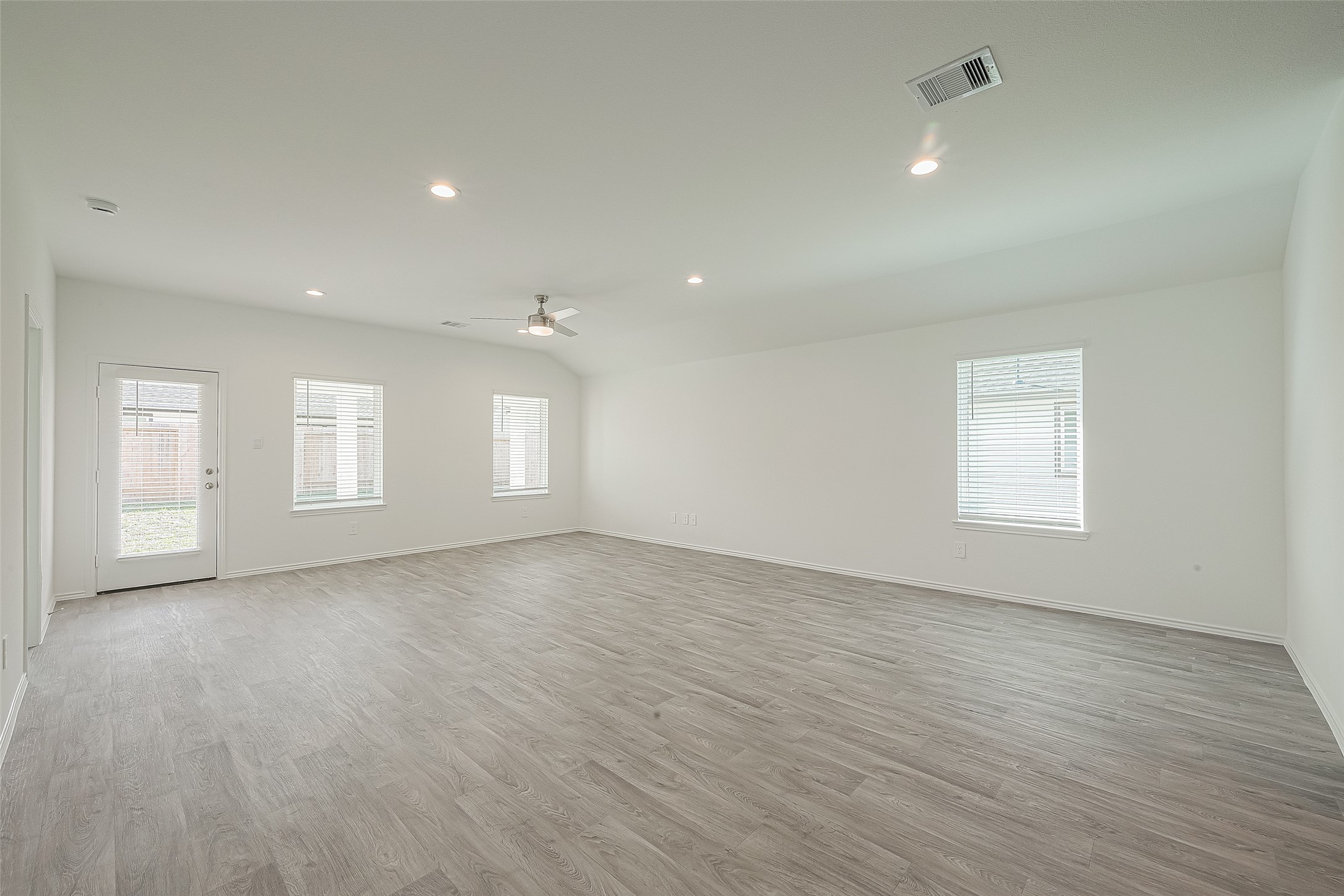 2731 Willow Gulch Way Rosenberg, TX 77469 - Photo 10 of 50 an empty room with wooden floor and windows