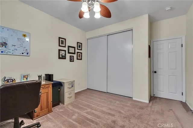 a workspace with furniture and ceiling fan