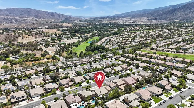 an aerial view of a house with a yard