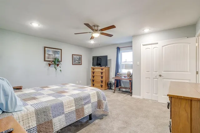 a view of a house with backyard and a tree