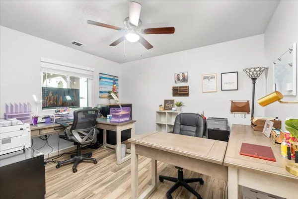 a view of a workspace with furniture and a workspace