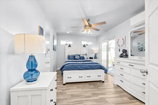 a spacious bedroom with a bed and cabinet