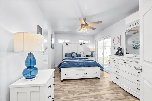 a spacious bedroom with a bed and cabinet