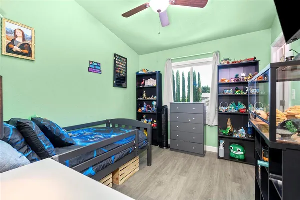 a bedroom with furniture and a book shelf