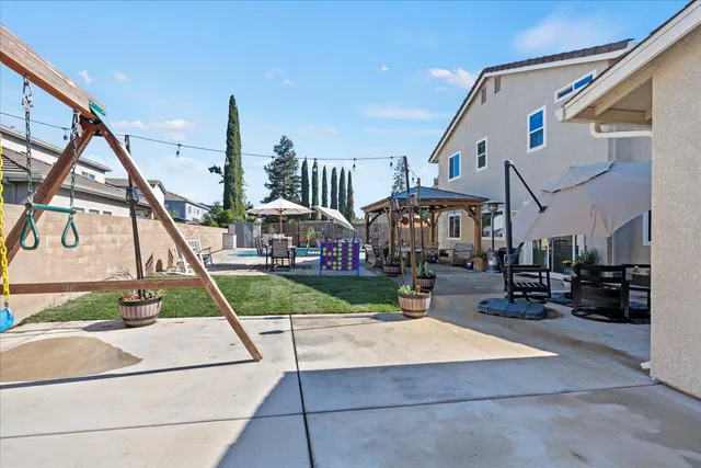 a view of a house with backyard porch and sitting area