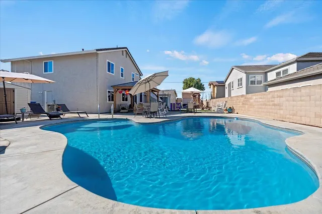 an aerial view of a house with outdoor space and lake view in back