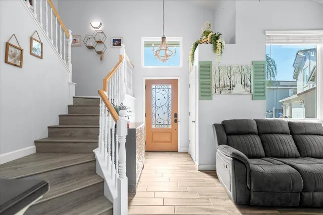 a view of entryway and hall with wooden floor