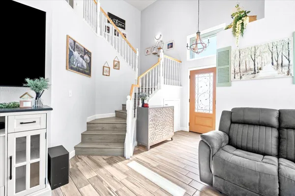 a living room with furniture and a chandelier