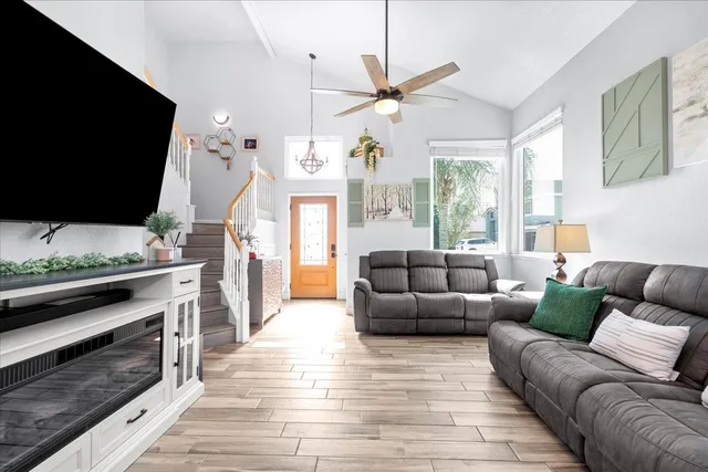 a living room with furniture fireplace and flat screen tv