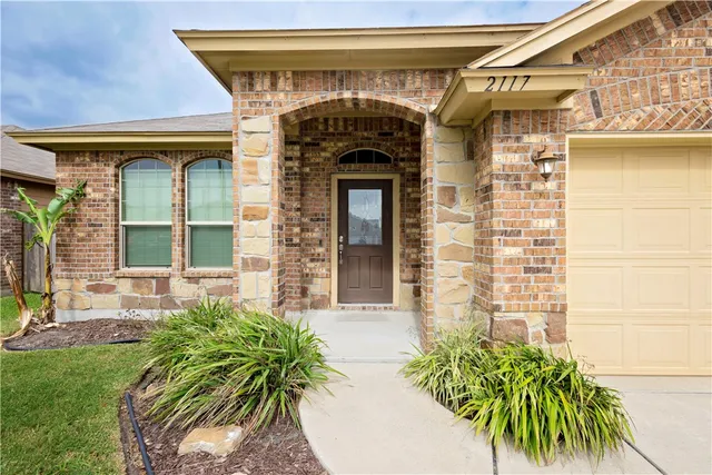 a front view of a house with a garden