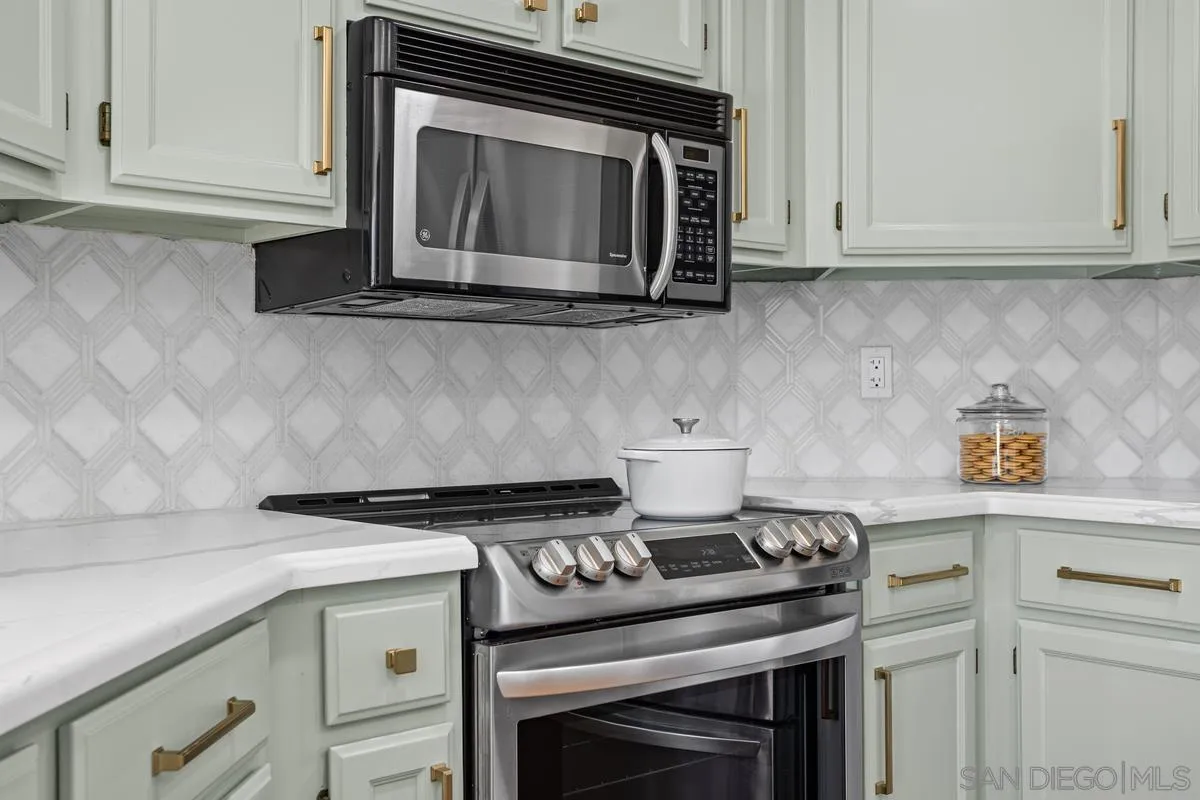 1201 Rue St Jean San Marcos, CA 92078 - Photo 13 of 73 a kitchen with a stove and a microwave