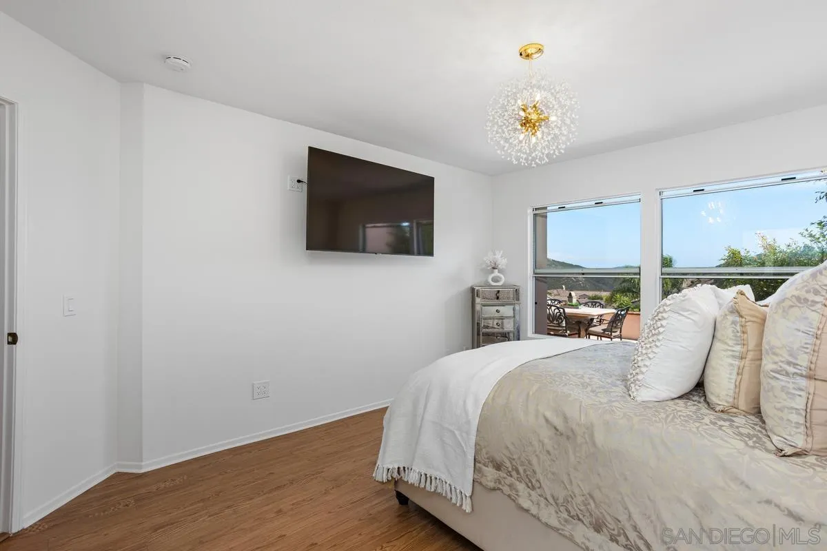 1201 Rue St Jean San Marcos, CA 92078 - Photo 30 of 73 a bedroom with a bed and a flat screen tv
