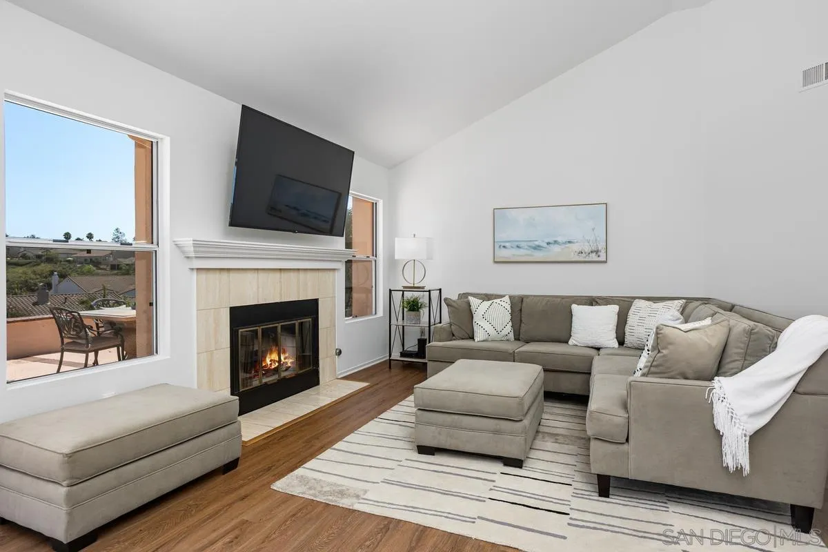 1201 Rue St Jean San Marcos, CA 92078 - Photo 5 of 73 a living room with furniture a flat screen tv and a fireplace
