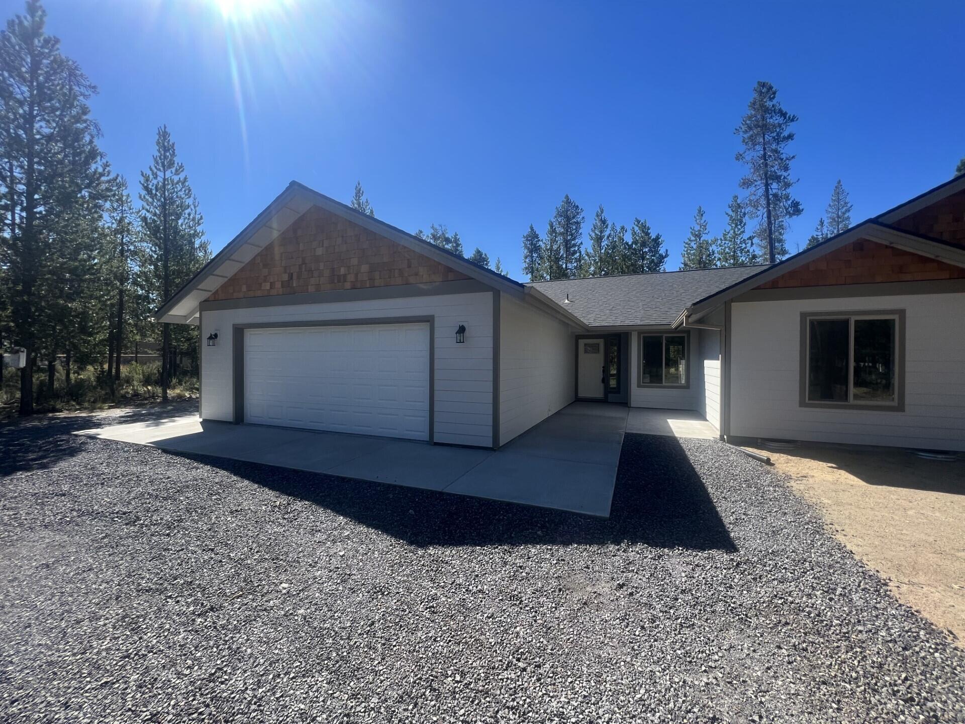 17163 Bakersfield Road Bend, OR 97707 - Photo 2 of 22 a front view of a house with a yard and garage