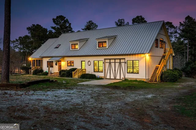 a view of a house with a yard and table in front of it