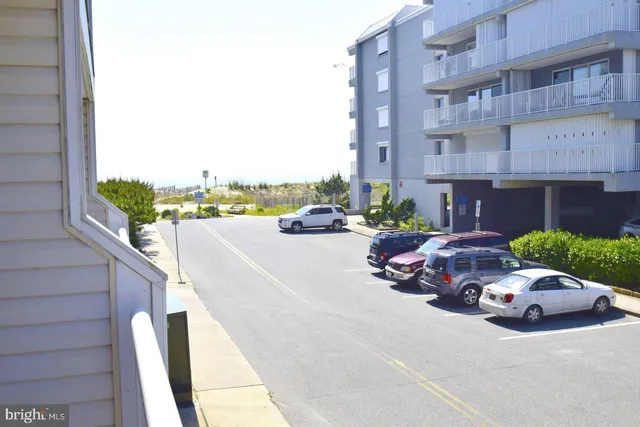 a couple of cars parked in front of a building