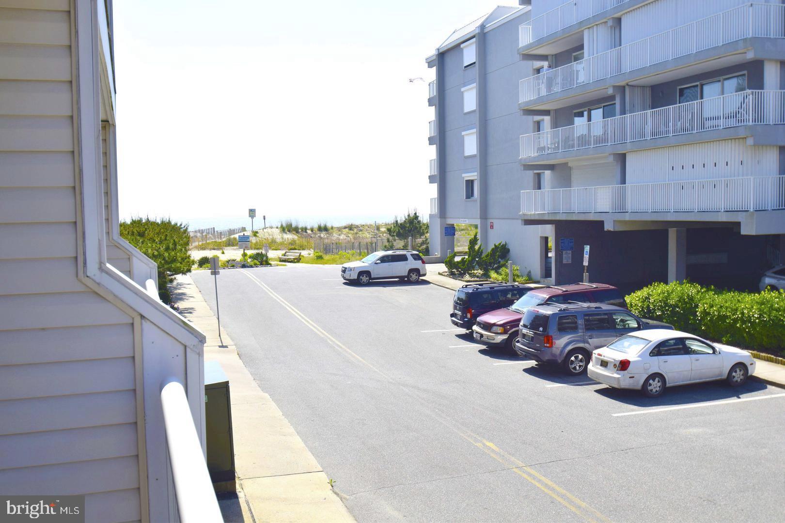 12 77th Street, Unit 103 Ocean City, MD 21842 - Photo 2 of 14 a couple of cars parked in front of a building