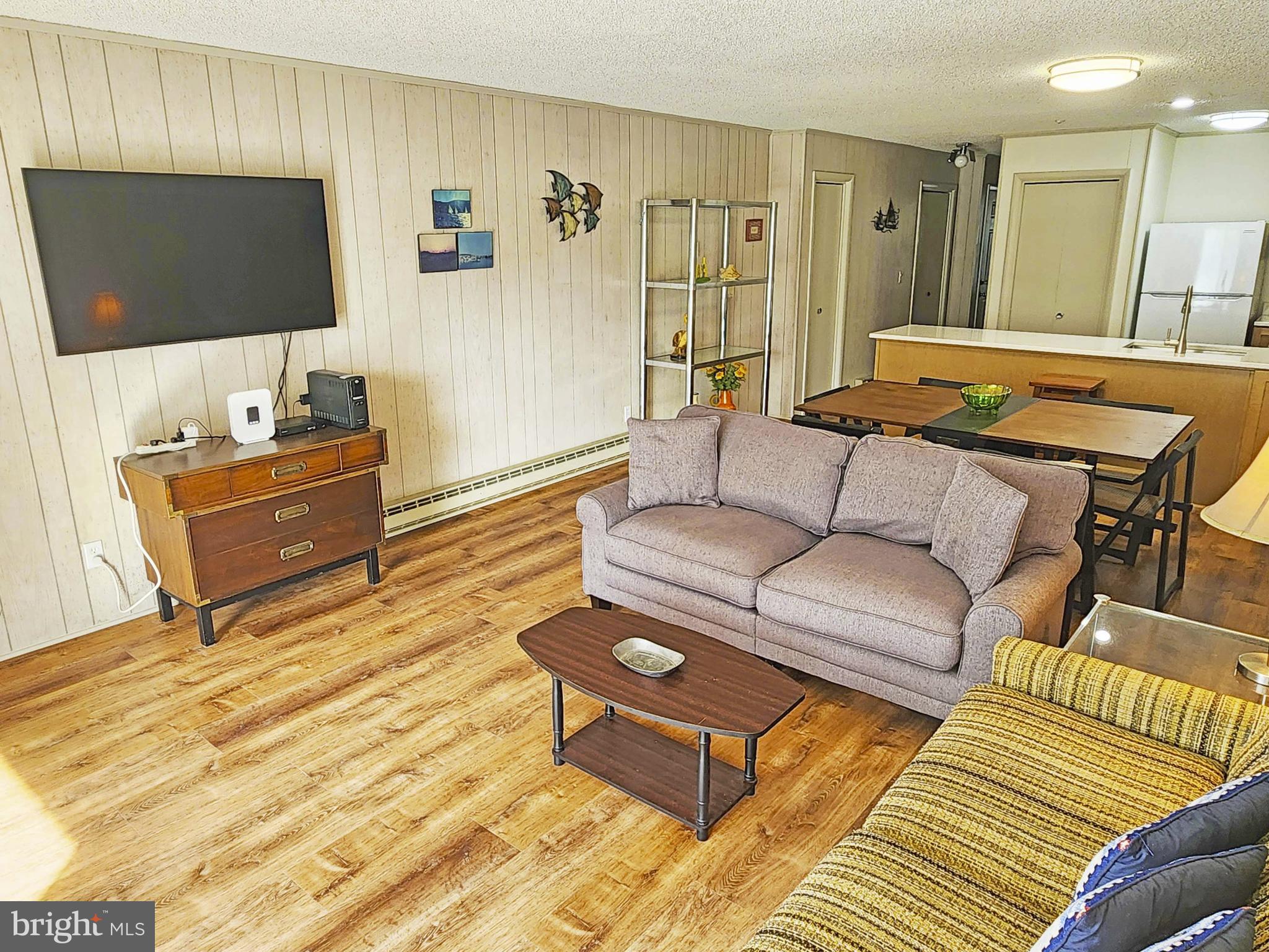 12 77th Street, Unit 103 Ocean City, MD 21842 - Photo 3 of 14 a living room with furniture and a flat screen tv