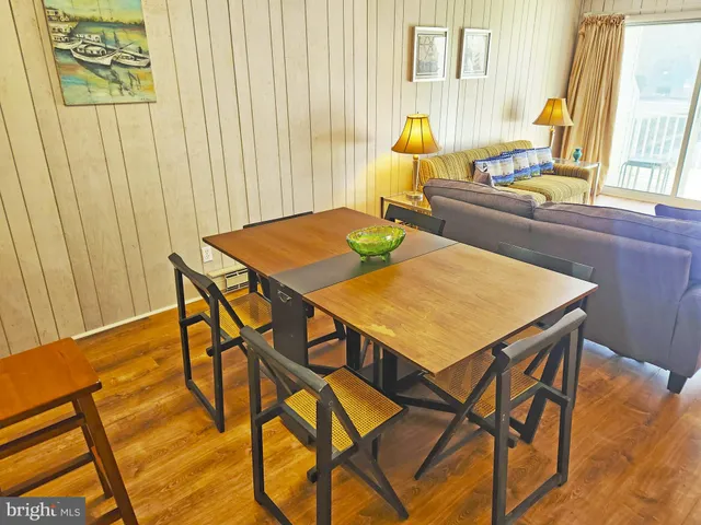 a view of a dining room with furniture and a window