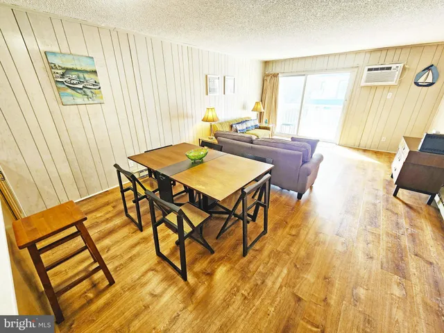 a view of a dining room with furniture and a window