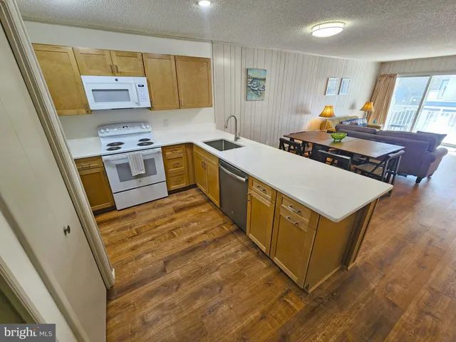 a kitchen with sink cabinets and wooden floor