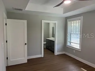 a view of an empty room with closet and a window