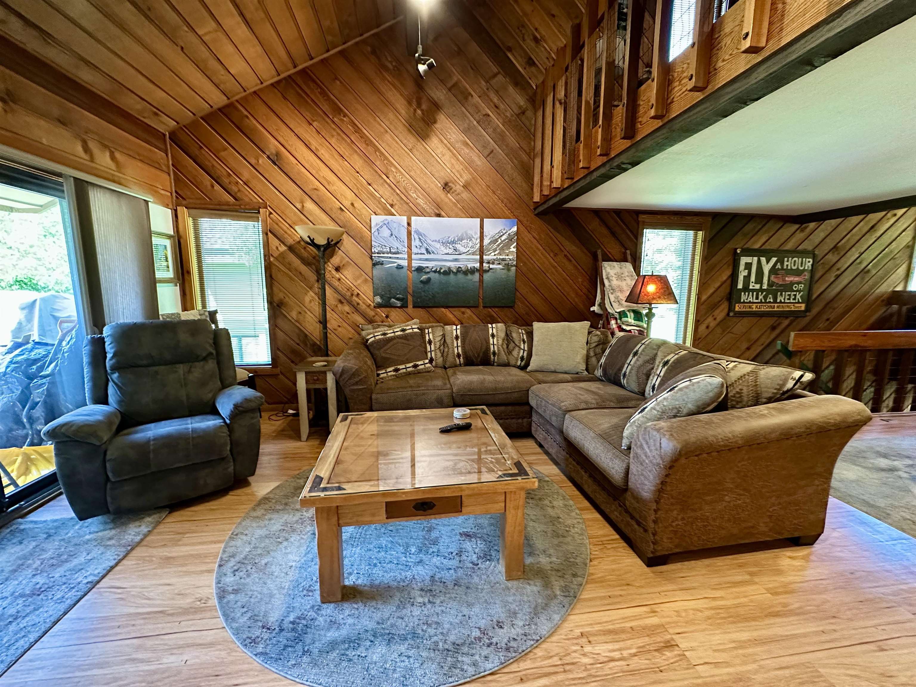 315 Fascination, Unit 315 Mammoth Lakes, CA 93546 - Photo 39 of 44 Vaulted wood-paneled ceilings with exposed beams, wood-finish flooring, and a sliding glass door