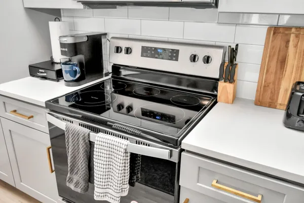 a stove top oven sitting inside of a kitchen
