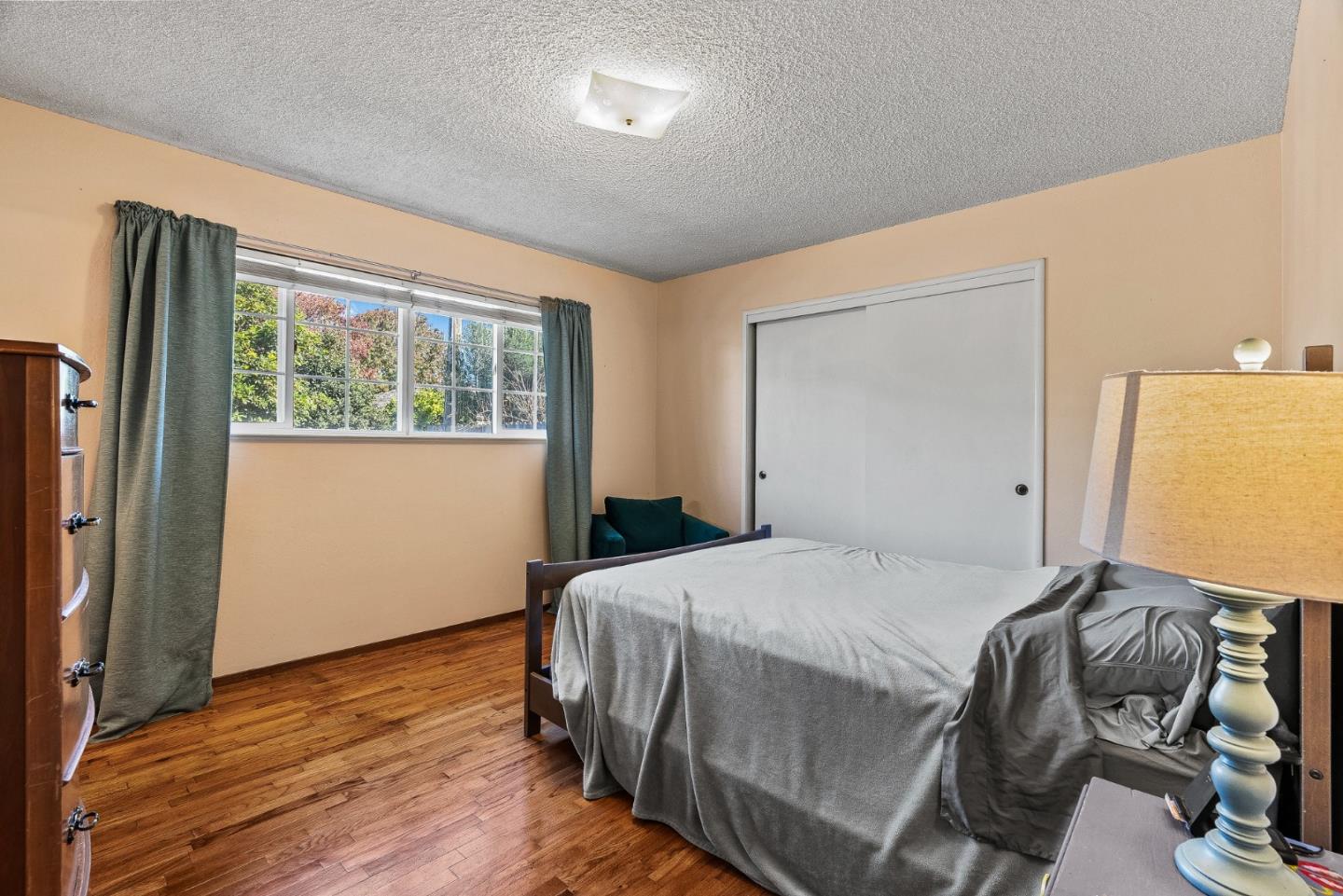 842 Central Avenue Salinas, CA 93901 - Photo 12 of 24 a bedroom with a bed and wooden floor