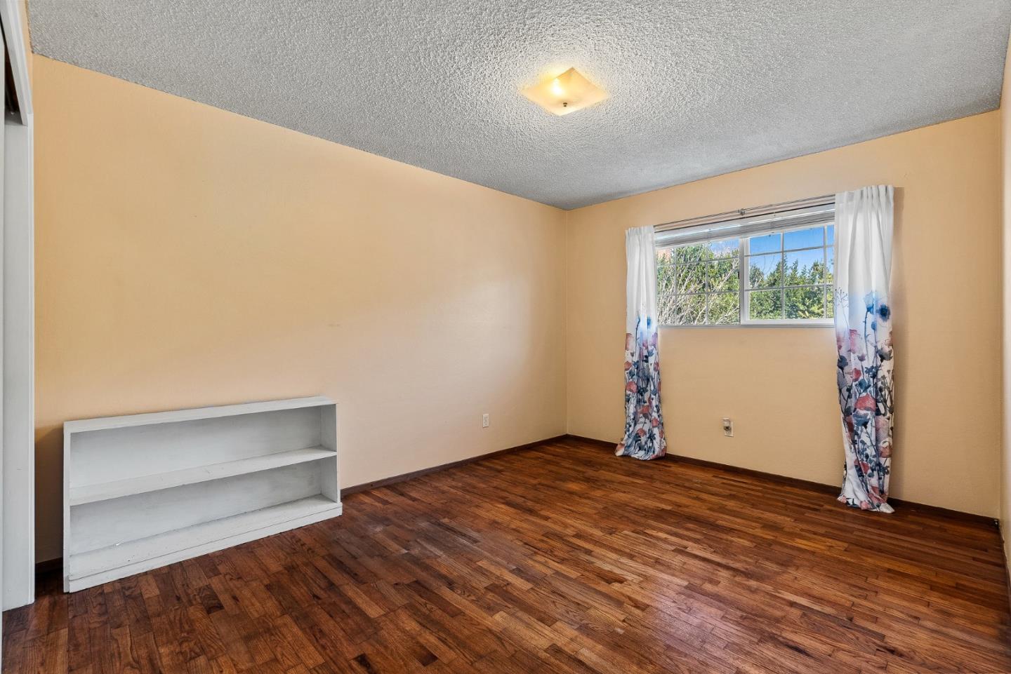 842 Central Avenue Salinas, CA 93901 - Photo 15 of 24 an empty room with wooden floor and windows