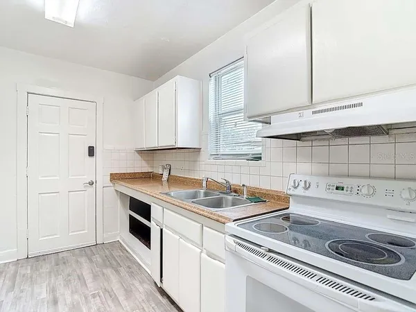 a kitchen that has a sink and a stove